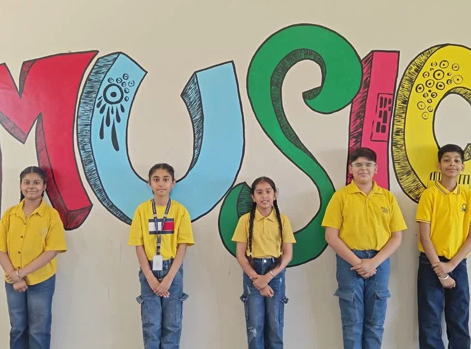 Students sharing Punjabi music in front of a colourful music mural